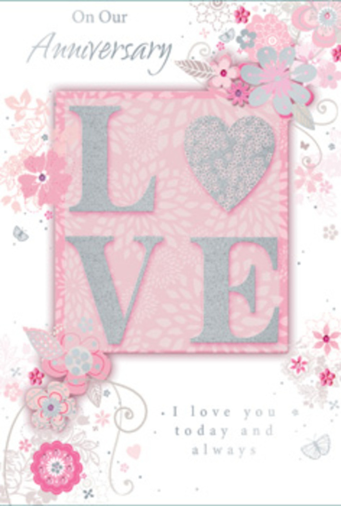 This beautifully photographed anniversary card feels like a paper bouquet laid out in the soft afternoon light of an Abbots Langley living room. The central focus is the word LOVE, set in large, raised letters that sparkle with a frosted glitter finish, blending blush pink and pearlescent white with delicate silver highlights. The texture looks invitingly touchable, recalling the gentle roughness of glittered ribbon threaded through an anniversary bouquet. Surrounding this central word, wispy, hand-drawn floral sprays drift toward the edges of the card, their petals and leaves unfurling in soft shades of pink, lilac, and ivory. The blooms are stylised yet graceful, their fine outlines and subtle shading suggesting the skill of a florist sketching out a romantic arrangement for delivery to a home near Bedmond or along Abbots Langley's quiet lanes. Light filigree curls, dainty leaves, and small, almost-hidden butterflies weave through the composition, giving a feeling of fluttering movement-like the gentle stir of petals when a bouquet is first unwrapped. The background is a gentle blush pink, evenly lit, creating a calm, tender atmosphere that lets the glimmering letters and detailed florals stand out. Nestled among the design is a message in understated, flowing type: loving words that echo I love you today and always, expressing devotion without overpowering the artwork. The overall mood is intimate and reflective, perfect for a couple marking another shared year together. It suggests a moment of pause-a card opened at the breakfast table, perhaps beside a vase of fresh roses and lilies from a local Abbots Langley florist, quietly honouring everyday love.