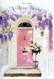 A tranquil doorway scene in Abbots Langley unfolds like a housewarming card brought to life. A pale, painterly pink door stands quietly at the centre, framed by whitewashed walls and a single, softly tinted shutter that hints at cottage charm familiar to anyone wandering the streets around the village centre. Cascading from above, luxuriant wisteria trails down in long clusters of lavender, lilac, and soft purple, forming natural garlands that create a romantic archway over the entrance. Light filters through the blooms and leaves, scattering gentle, shifting shadows over the step and giving the impression of a mild spring afternoon drifting in from nearby green spaces like Leavesden Country Park. At the doorstep itself, a classic metal florist's bucket in weathered grey has been placed with intention. It is abundantly filled with creamy white roses, each bloom full and velvety, their layered petals unfolding in soft spirals that seem to cradle the light. Sprigs of fresh, mid-green foliage peek between the roses, adding texture and a sense of just-cut garden freshness. Around the base of the bucket, a blush-pink satin ribbon is tied neatly, its sheen catching the light and echoing the soft pink of the door. The overall palette-lavenders, creams, whites, blushes-creates a serene, pastel harmony. The mood is that of quiet celebration: perhaps the flowers have just been delivered to mark moving into a first home in Abbots Langley, or to congratulate someone on a new chapter. Every detail, from the trailing wisteria to the generous roses, works together to suggest warmth, welcome, and the beginning of many happy memories behind that door.